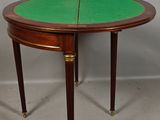 a small table with a green top and two legs