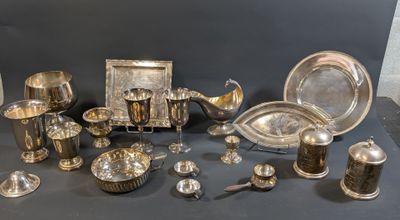 a table with a lot of silver items on it