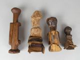 several wooden figurines are lined up on a white surface