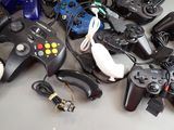 a lot of video game controllers sitting on a table