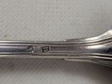 a silver spoon with a handle on a table