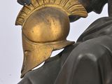 a bronze statue of a man with a helmet on his head