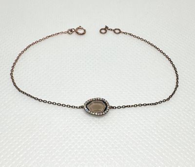 Bracelet fin en or rose 18K 750/1000 orné d'un motif central…