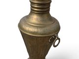 a large metal vase with a handle on a white background