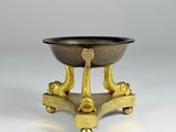 an image of a brass bowl on a stand with two legs