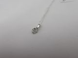 a close up of a small silver object on a white surface
