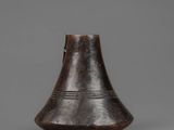 an old metal bell with a wooden handle on a gray background