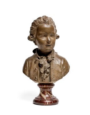 bronze bust of a young boy wearing a bow tie on a pedestal
