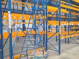 a large warehouse racking system with a dolly dolly in the middle of it