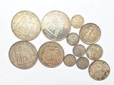 some coins are sitting on a white surface with a white background