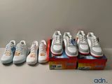 several pairs of shoes are lined up in a row on a table