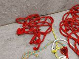 a white purse and a red rope on the ground