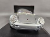 a silver toy car sitting on top of a black table