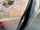 a close up of a car ' s door handle with a sticker on it