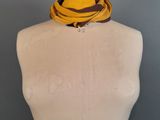 yellow and brown scarf on a mannequin torso