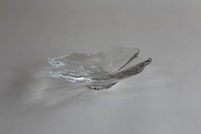 a small glass bowl on a table with a spoon