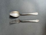 two spoons and a fork sitting on a table