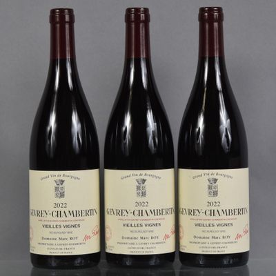 three bottles of wine are lined up on a table