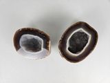 two pieces of agate sitting on a white surface