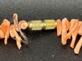 a close up picture of a knife and some carrots on a table