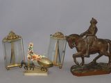 a statue of a man riding a horse next to a mirror