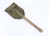 an old shovel with a wooden handle on a white surface