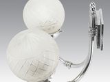 a wall light that has two balls attached to it