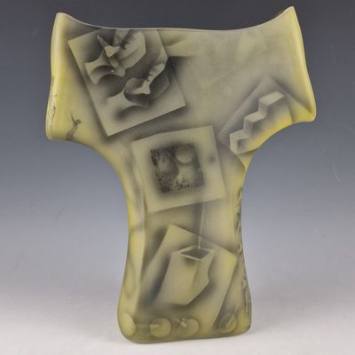 un gros plan d'un vase posé sur une table, sur fond gris