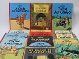 several children ' s books are lined up on a white surface