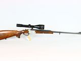 a rifle with a scope on a white background