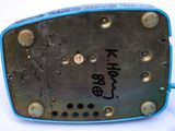 a metal object with rivets on it on a white surface