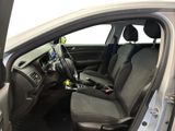 the interior of a car with the door open and the driver ' s seat down
