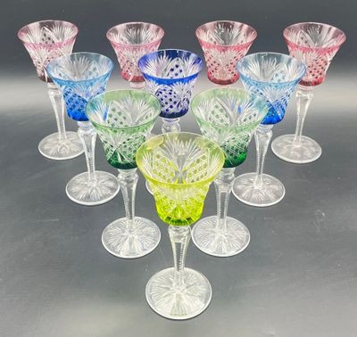 a set of six multicolored wine glasses sitting on top of a table