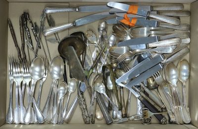 a box full of silver spoons and forks in it