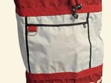 a red and white tote bag with the word mcq on it