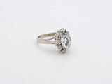 an oval aquamarinee and diamond ring on a white background