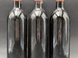three bottles of wine sitting next to each other on a table