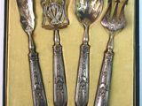 four spoons and a fork in a box