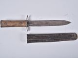 a knife and a knife holder on a white surface