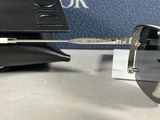 christian dior sunglasses with box and case on a table
