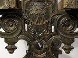 a large metal candle holder that has a cross on it