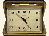 a clock that is sitting in a case on the table