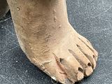 a close up of a statue of a person ' s feet