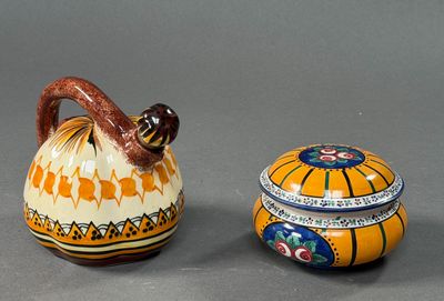 two small vases sitting next to each other on a table