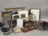 a lot of picture frames and pictures on a table
