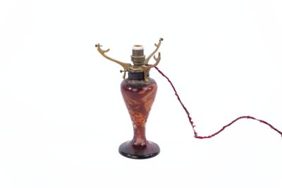 a picture of a lamp that has a red cord attached to it
