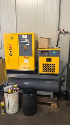 two air compressors sitting on top of a table