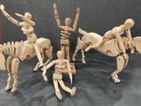 three wooden figurines of people riding horses and a man on a horse