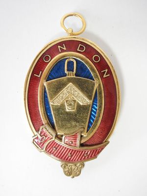 an image of a gold and red badge with a birdhouse on it
