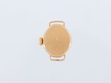 a close up of a gold watch on a white surface